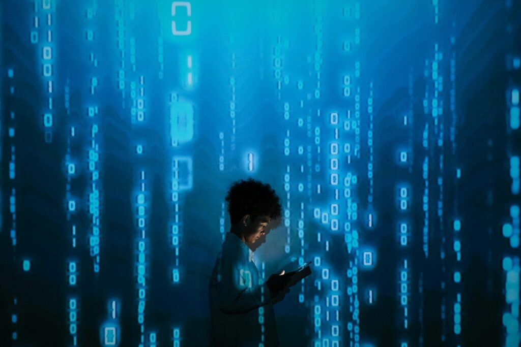 Silhouette of a person using a smartphone surrounded by digital binary code projections.